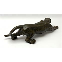 A bronze figure, modelled as a cougar in crouching pose, signed Milo and with foundry mark, L40cm.
