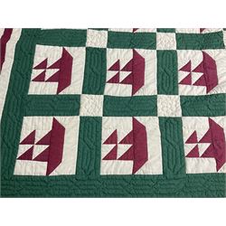 20th century quilt, with repetitive ship design to the centre within a cream red and green boarder, 227cm x 222cm