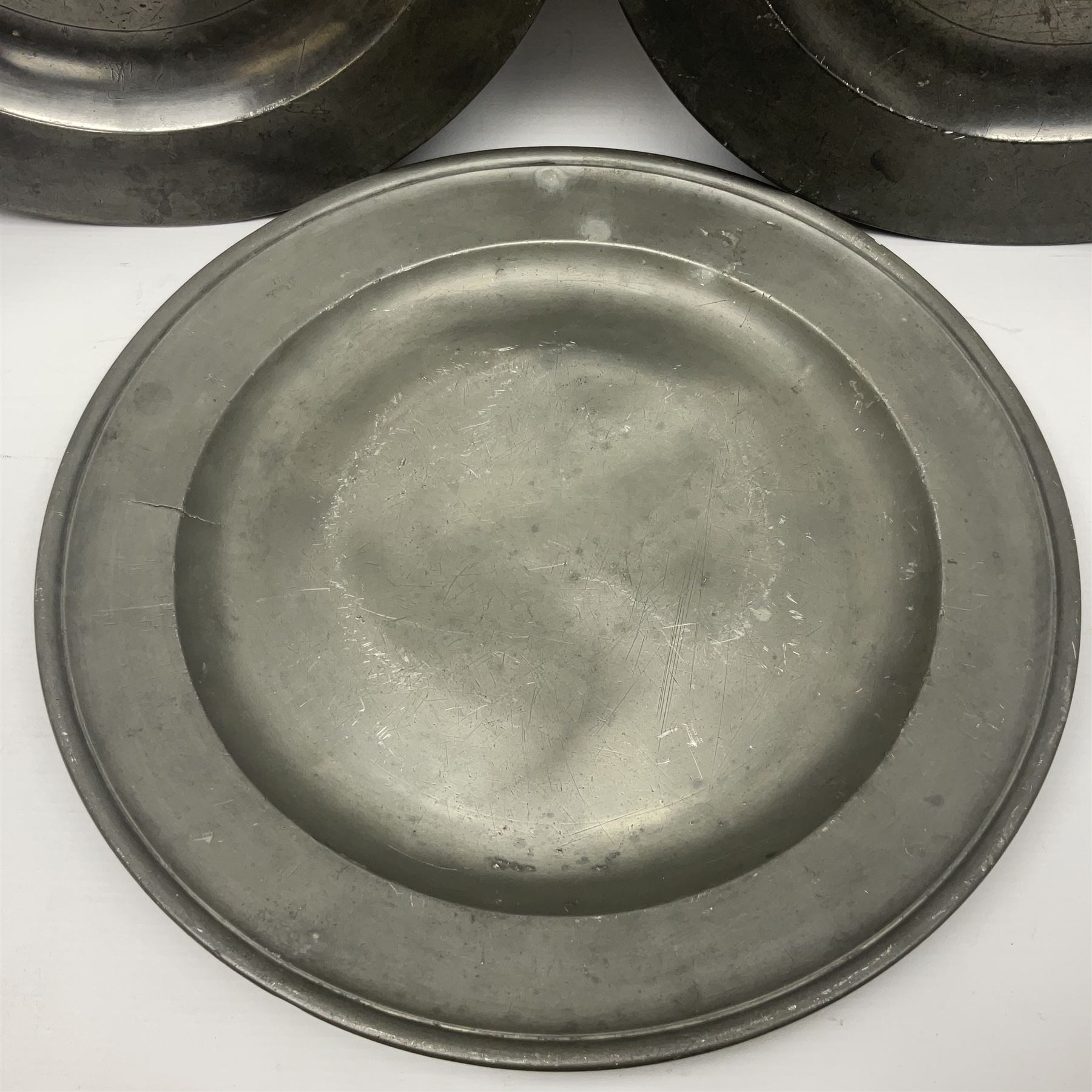 Group of seven 19th century pewter chargers, each of circular form with dished centre, two examples with touch marks verso, each approximately D39cm