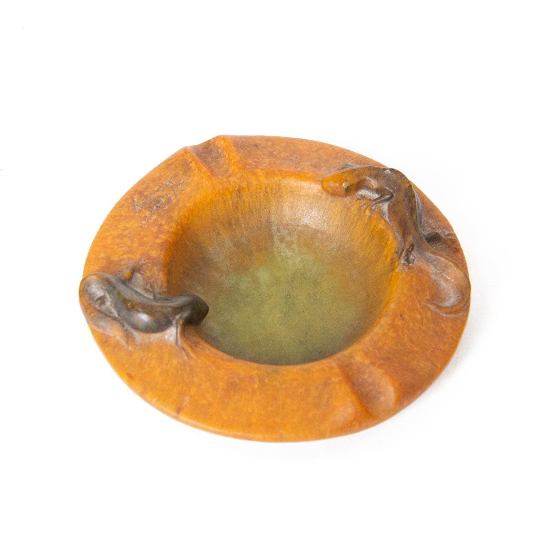 Amalric Walter (1870-1959) and Henri Berge (1868-1936), Nancy, France, circa 1920, pate de verre, Salamander ashtray, bearing moulded mark 'A Walter Nancy' and incised mark 'Berge sc.', D12cm

Note: Almaric Walter, born in Sèvres near Paris, exhibited at the Salon des Artistes Françaises in 1895 and 1903, and in 1908 moved to Nancy where he established his own workshop within the Daum glassworks. There he worked closely with Daum designers, including Henri Bergé. This ashtray is an example of Walter’s pâte-de-verre technique.

Provenance: From the collection of Andrew Chichester Everitt.
