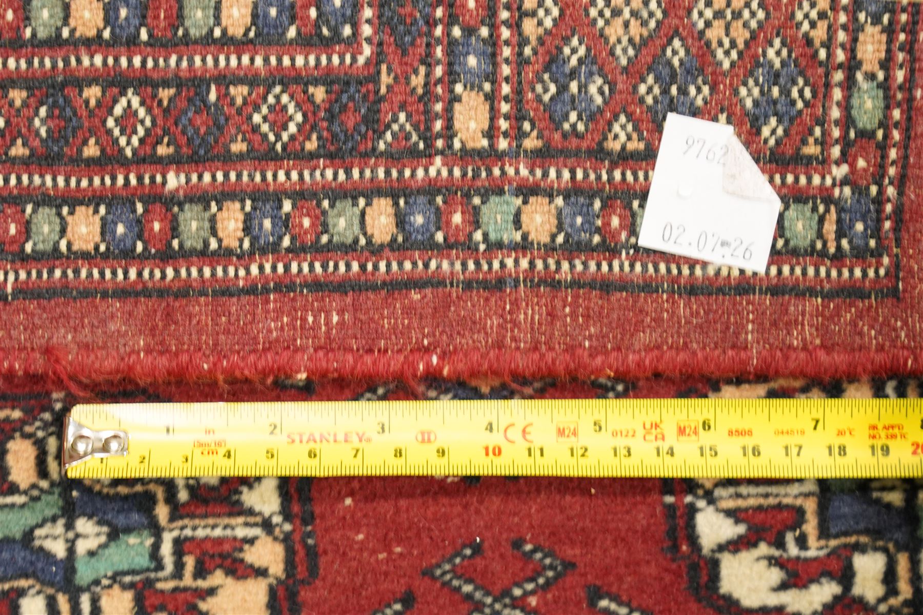 Two hand-knotted rugs, comprising Turkoman Ersari rug and Bokhara rug, Turkoman Ersari hand-knotted rug, terracotta ground with two rows of repeating octagonal guls interspersed with geometric motifs, enclosed by multiple geometric borders, fringed ends, H125cm, W93cm; Bokhara hand-knotted rug, madder red ground with three rows of repeating Tekke guls interspersed with geometric motifs, enclosed by multiple stylised floral and geometric borders, fringed ends, H188cm, W126cm
