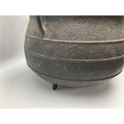 Late 17th century cast iron cauldron, of bellied form with girdle bands and twin angular handles, upon tripod feet, H26.5cm rim D33cm