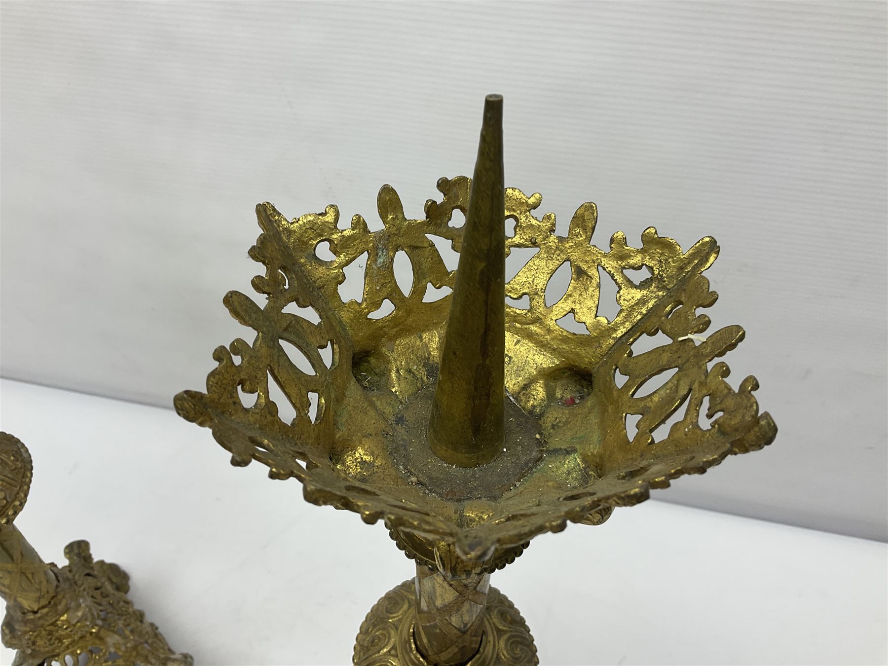 Pair of gilt metal pricket candlesticks, with applied decoration on knopt stems and triform bases, H47cm