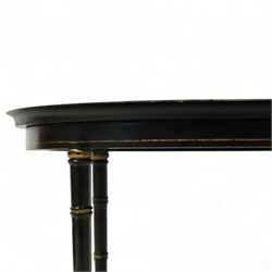 Regency style oval toleware tray table, the black lacquered top with gilt floral decoration, on ebonised faux bamboo frame with stretcher supports