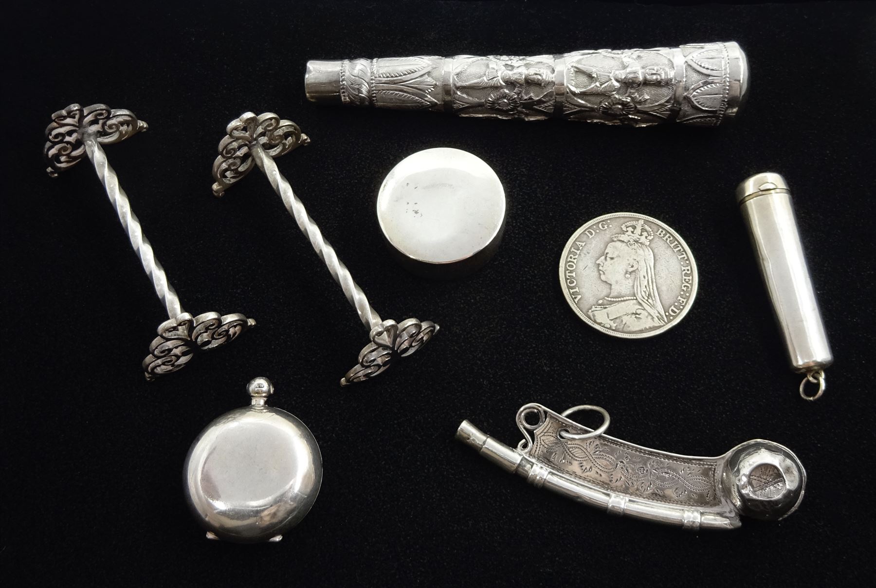 Edwardian silver sovereign holder by A & J Zimmerman Ltd,  Birmingham 1902, silver whistle by John Bettridge, Birmingham 1824, pair of silver knife rests by Josiah Williams & Co, London 1919, silver cheroot holder, Victorian 1889 silver crown, pill box and a silver Middle Eastern embossed mount