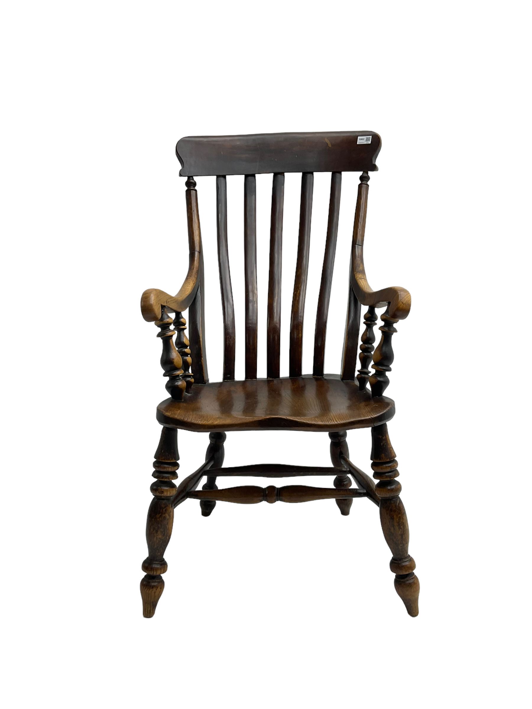 Late 19th century elm farmhouse armchair, high lath back raised on turned supports united by stretcher