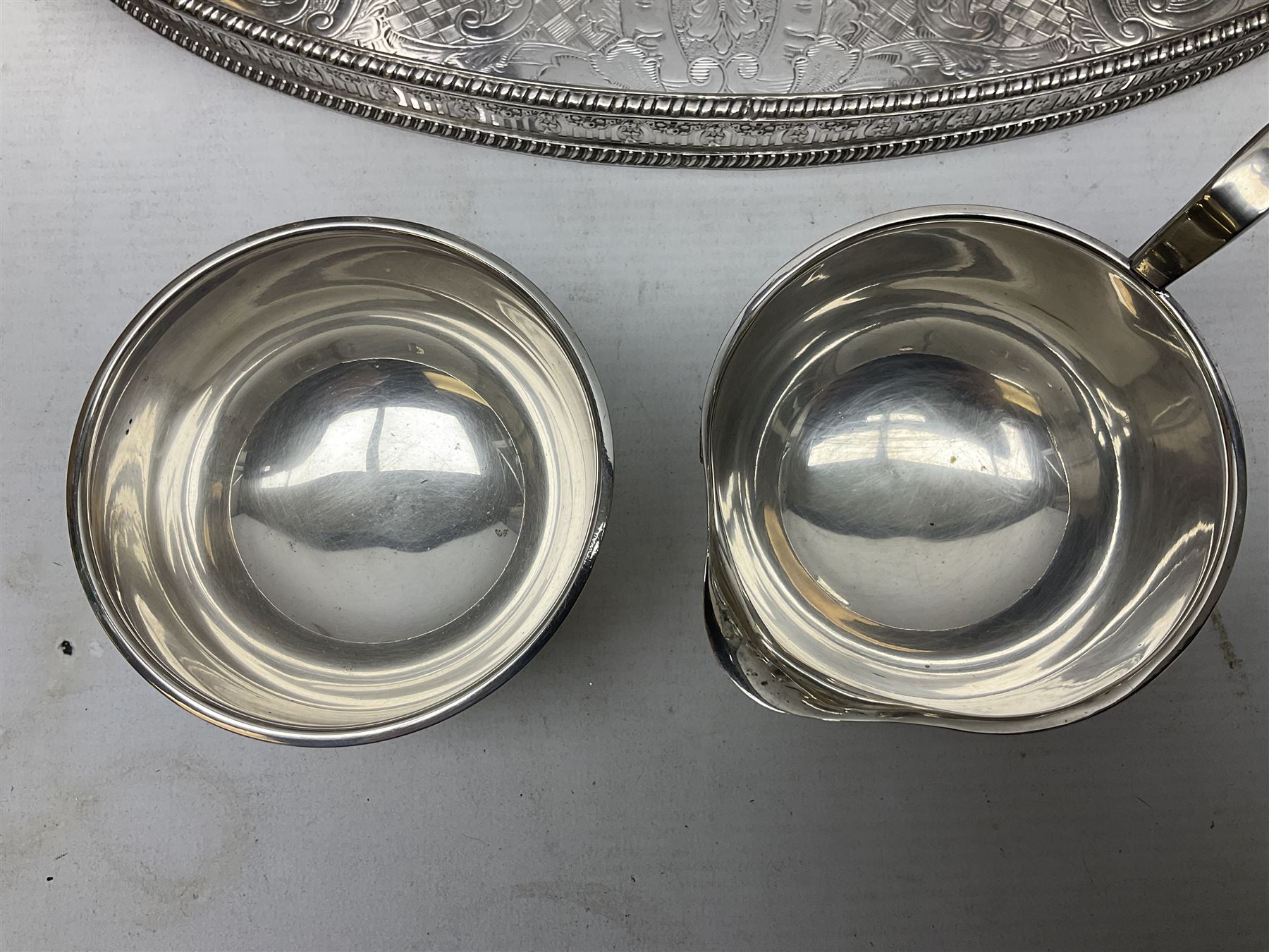 Viners of Sheffield silver-plate tea/coffee wares, the rims decorated with bands of flowers, and chased oval tray with swag decorated gallery, L39cm