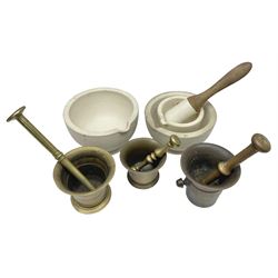Group of pestle and mortars to include heavy bronze example with twin handles, cream stoneware Wedgwood example,  brass examples etc