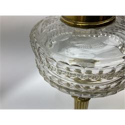 Victorian brass oil lamp, the square stepped base leading to a Corinthian column supporting a part slice cut clear glass reservoir, burner, clear glass chimney and foliate etched glass shade with amber rim, overall H80cm