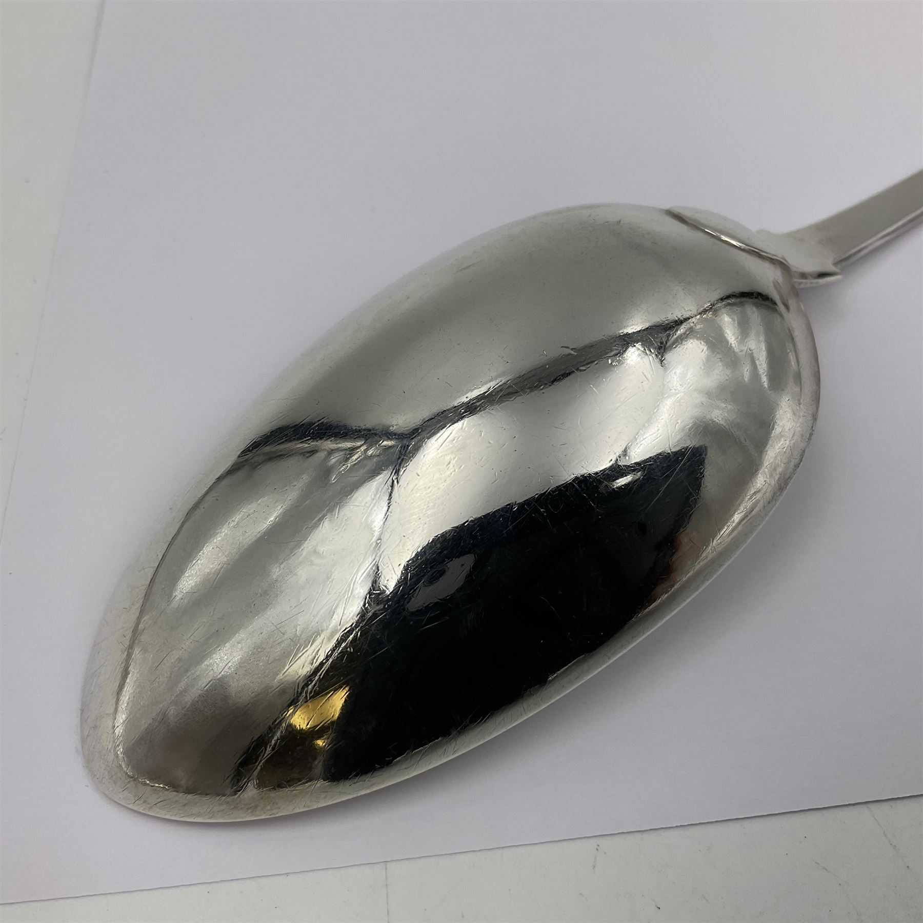 Victorian Newcastle silver Fiddle Shell pattern serving spoon, the terminal engraved with crest of a fist holding an arrow aloft, hallmarked Lister & Sons, Newcastle 1862, L31cm