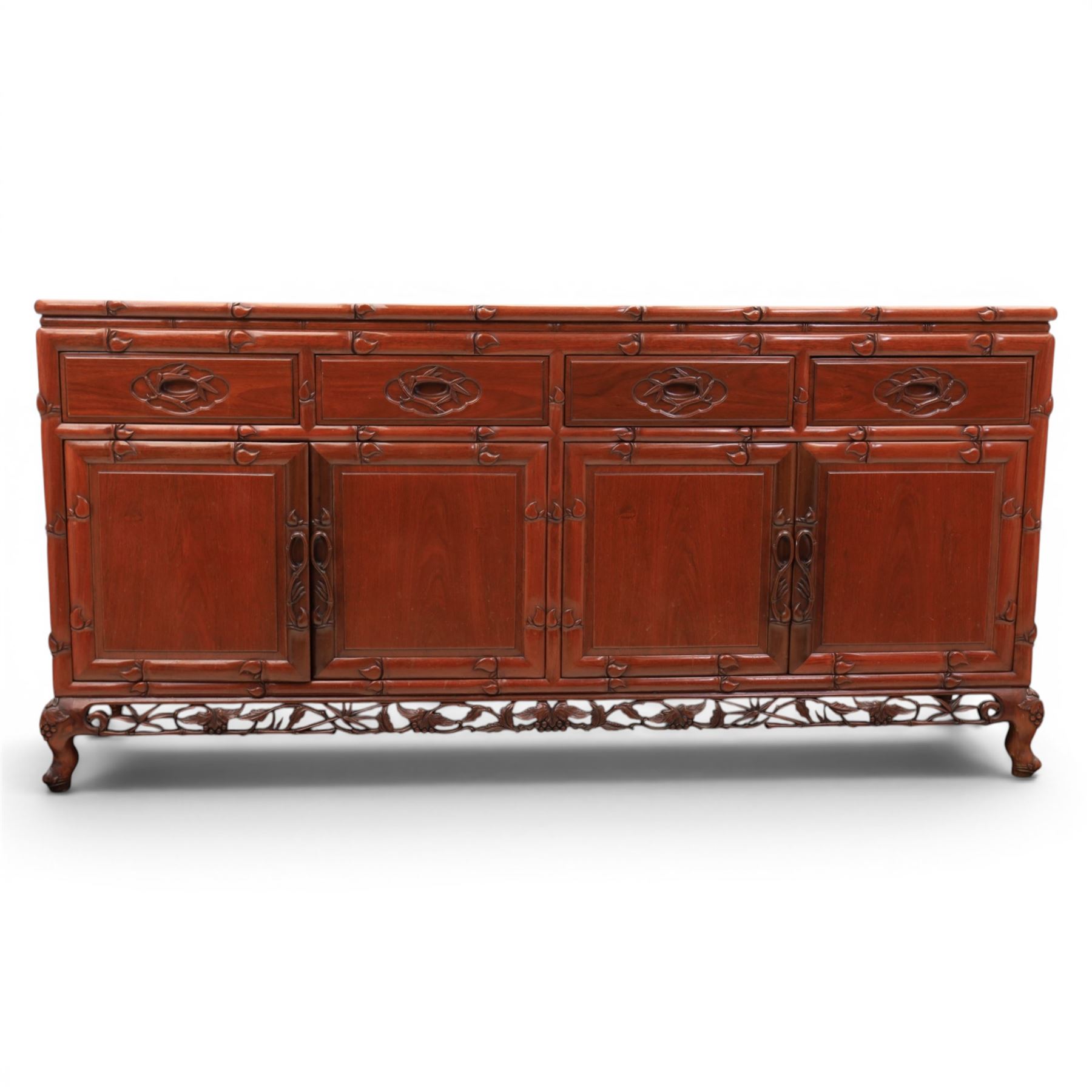 20th century Chinese ornately hardwood sideboard, rectangular top over four drawers above four cupboards, pierced carved apron, raised on cabriole legs 
