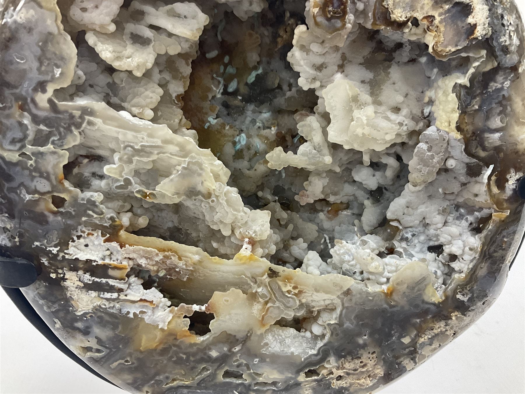 Large agate geode with quartz crystals to the centre, upon a metal stand, H35cm 