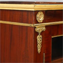 19th-century French Empire-style mahogany and gilt bronze-mounted glazed cabinet, rectangular top above frieze with applied gilt bronze laurel swags and rosettes with gilt brass borders, over two glazed panel doors enclosing three adjustable shelves, flanked by plain pilasters with applied mounts, raised on gilt bronze paw feet 