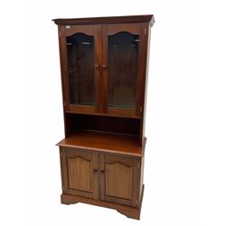 Mahogany bookcase on cupboard, two glazed doors