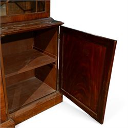 Fine Regency mahogany breakfront library bookcase, the stepped and moulded cornice over four astragal glazed doors enclosing adjustable shelves, the projecting central lower section with a pair of panelled doors enclosing three graduated drawers with brass inset handles above two deep zinc-lined cellarette compartments, flanked by panelled cupboard doors enclosing shelves, the figured mahogany fronts with ebony line inlay, on moulded plinth bases