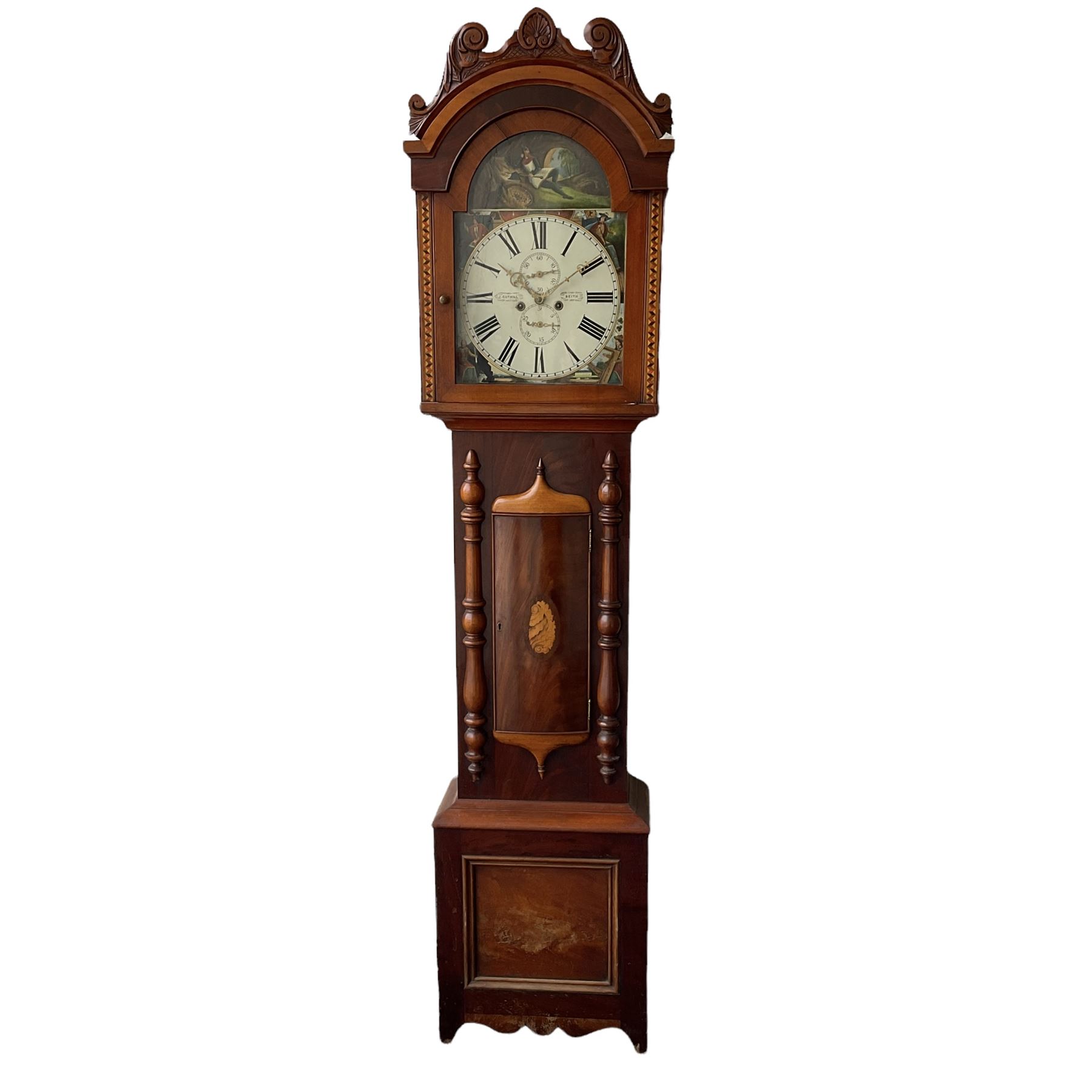 A Scottish longcase clock c 1890 in a contrasting light and dark mahogany veneered case, hood with a carved and crested pediment with a break arch door flanked by inlaid parquetry work, with a short trunk door and applied cushion mouldings, door flanked by half-turned applied columns on a square pediment with a recessed panel, fully painted break arch dial with spandrels representing the united kingdoms of Scotland, England, Ireland and Wales with a depiction of Robert Bruce to the arch, dial with Roman numerals ,minute track, subsidiary calendar dial and seconds dial with matching stamped brass hands, dial inscribed “J Cuthill, Beeth”, with an eight day striking movement,  striking the hours on a cast bell. With pendulum and two flat weights. 
John Cuthill is recorded as working as a watchmaker and clockmaker at 36 Eglington Street, Beith, Ayrshire. 1893.  

