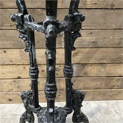 19th century cast iron table base, trefoil column with paw feet