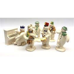 Royal Doulton The Snowman Gift Collection snowman band figures, comprising Cellist Snowman DS17, Violinist Snowman DS11, Drummer Snowman DS15, and Pianist Snowman DS12, plus Snowman's Piano DS13, together with two further figures The Snowman DS2, and The Snowman Snowballing DS22. (7). 