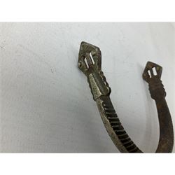 Pair of late 19th century South American iron spurs, engraved silver mounts, with sunburst rowls