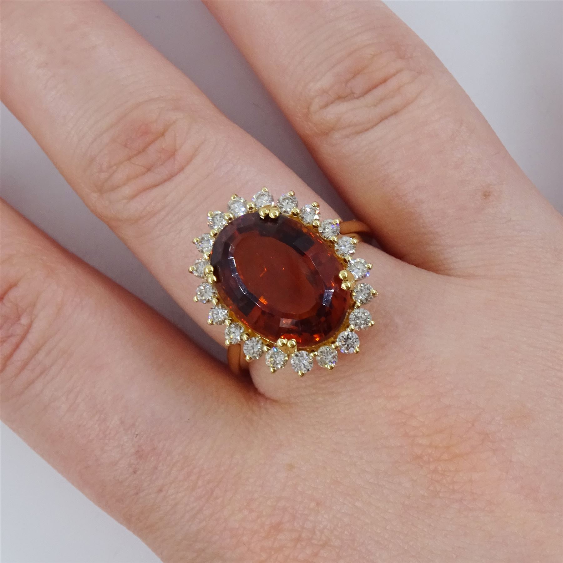18ct gold citrine and diamond cluster ring, single oval cut citrine of approx 7.35 carat, with round brilliant cut diamond surround, stamped, total diamond weight approx 0.75 carat