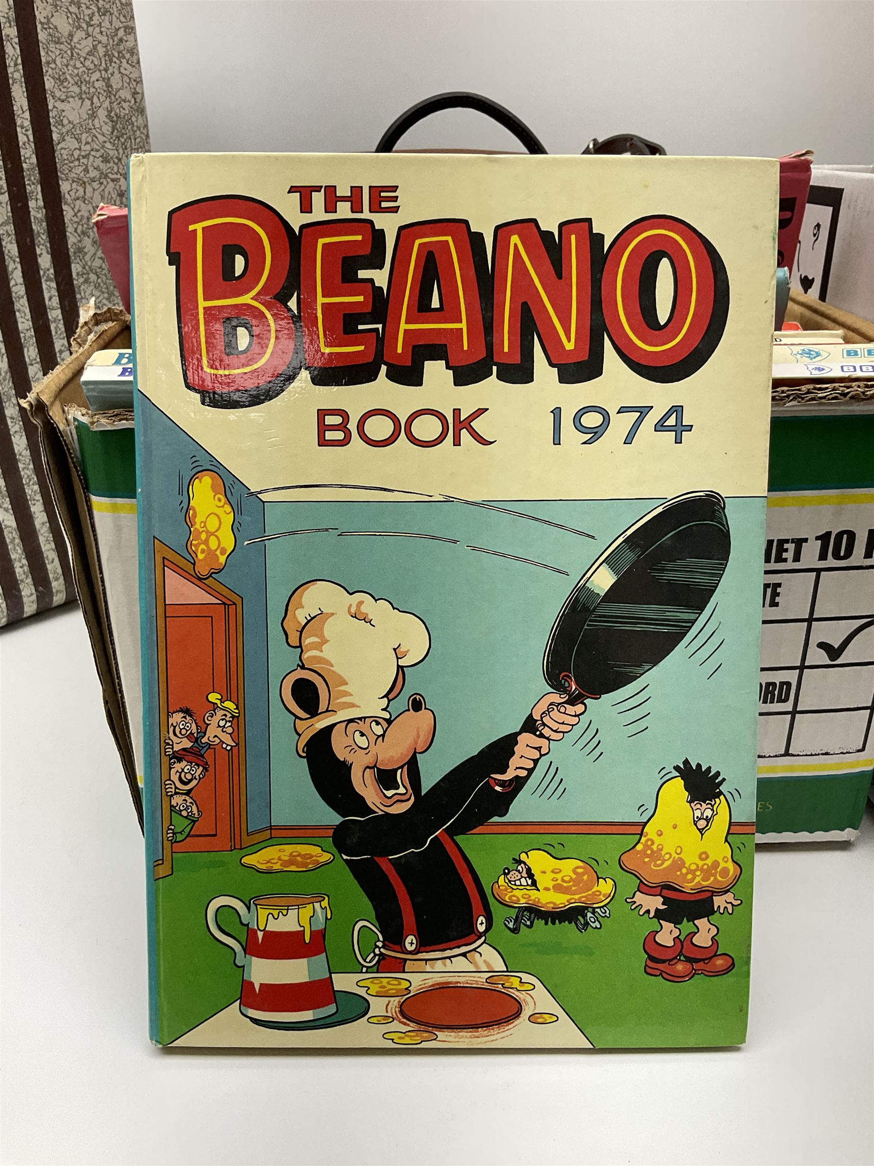 Collection of silver plated cased cutlery including part canteens and butter knives, together with other metal ware including J&J Siddons iron, horse brasses and a copper kettle, 1970s children's annuals including Beano, two handbags and three suitcases, vintage tins etc, in four boxes 