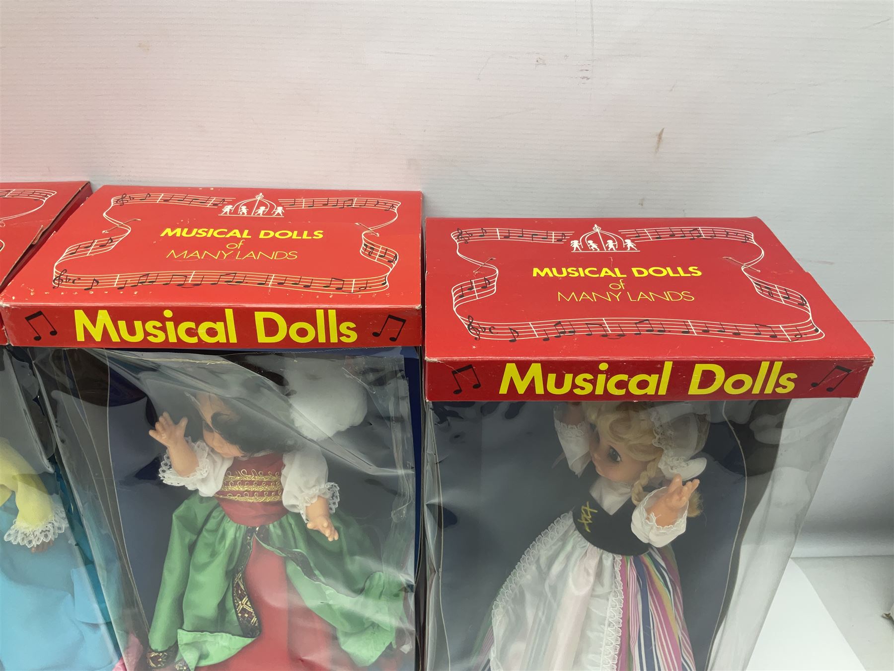 Four Mayfair Products Musical Dolls of Many Lands; original boxes and delivery boxes; and set of twelve Nationality Dolls with Sleeping Eyes; boxed (16)