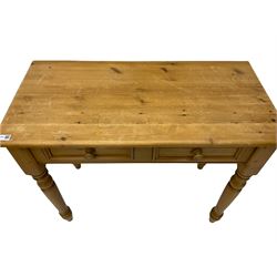Traditional waxed pine side table, fitted with two drawers, on turned supports