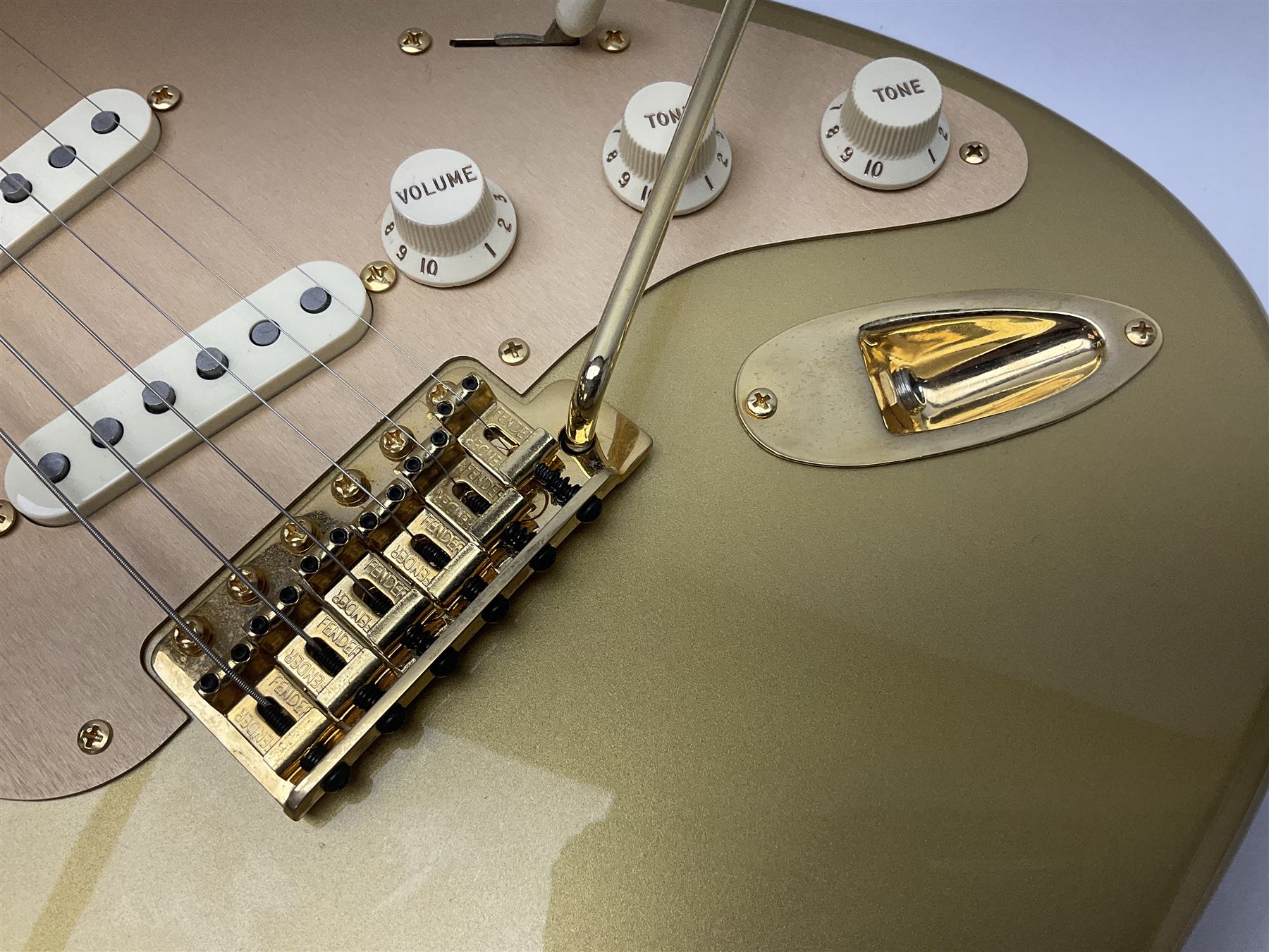 Fender Stratocaster 50th Anniversary 2004 metallic gold electric guitar; serial no.MZ4116369; L98cm; in Spider fitted case with owners manual and other paperwork, strap and belt buckle etc