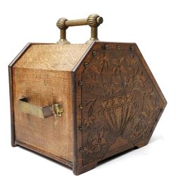 Arts & Crafts period oak coal box, each side carved with urn and spilling flowers, the cover with typical motifs, single carrying handle 
