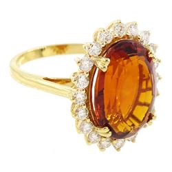 18ct gold citrine and diamond cluster ring, single oval cut citrine of approx 7.35 carat, with round brilliant cut diamond surround, stamped, total diamond weight approx 0.75 carat
