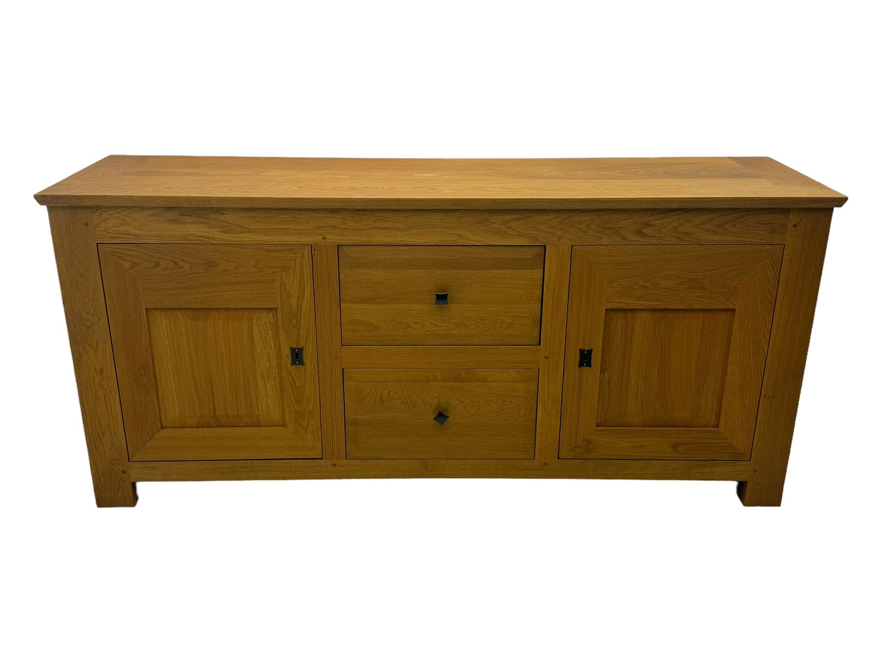 Contemporary light oak sideboard, chamfered rectangular top over two central bevel-edged drawers, flanked by two recessed panelled cupboards enclosing shelving, on square stile supports