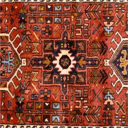 North West Persian Heriz hand-knotted runner, terracotta field decorated with a series of large angular medallions with stylized geometric motifs, surrounded stepped devices, and stylized trees within narrow geometric border, and polychromed edge, cotton fringe ends 