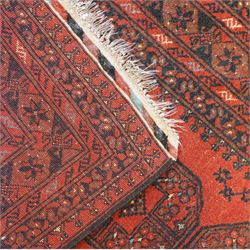 Bokhara red ground rug, the field decorated with three Gul motifs, within multiple borders with repeating geometric patterns (146cm x 103cm); together with an Afghan rug (144cm x 100cm)