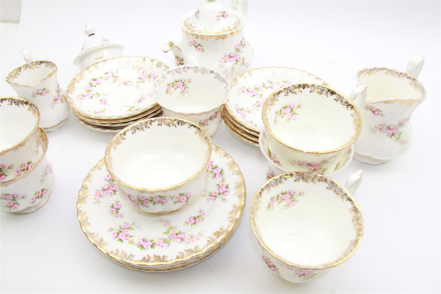 Royal Albert Dimity Rose pattern tea service for six place settings, including teapot, teacups and saucers, sugar bowl and two milk jugs, all with printed mark beneath