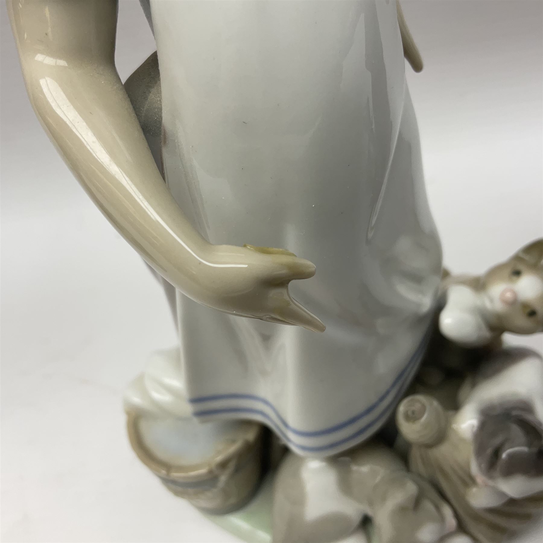 Five Lladro figures, including The Lamp Lighter no 5205,  Girl and Kittens no 6102, Cat no 5113 etc