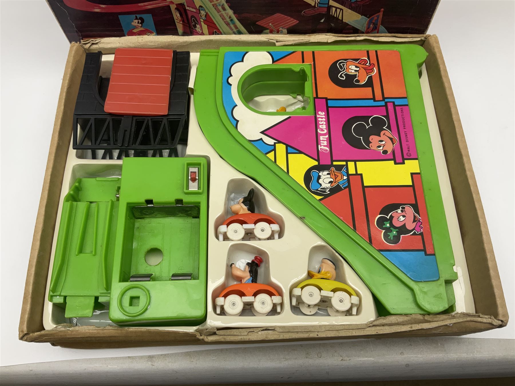 Mickey Mouse Trick Star battery operated drummer figure; Illco Mickey Mouse battery operated Fun Castle Roller Coaster; battery operated Western Express Locomotive; and JK Wells Fargo Overland Stage scale model; all boxed (4)