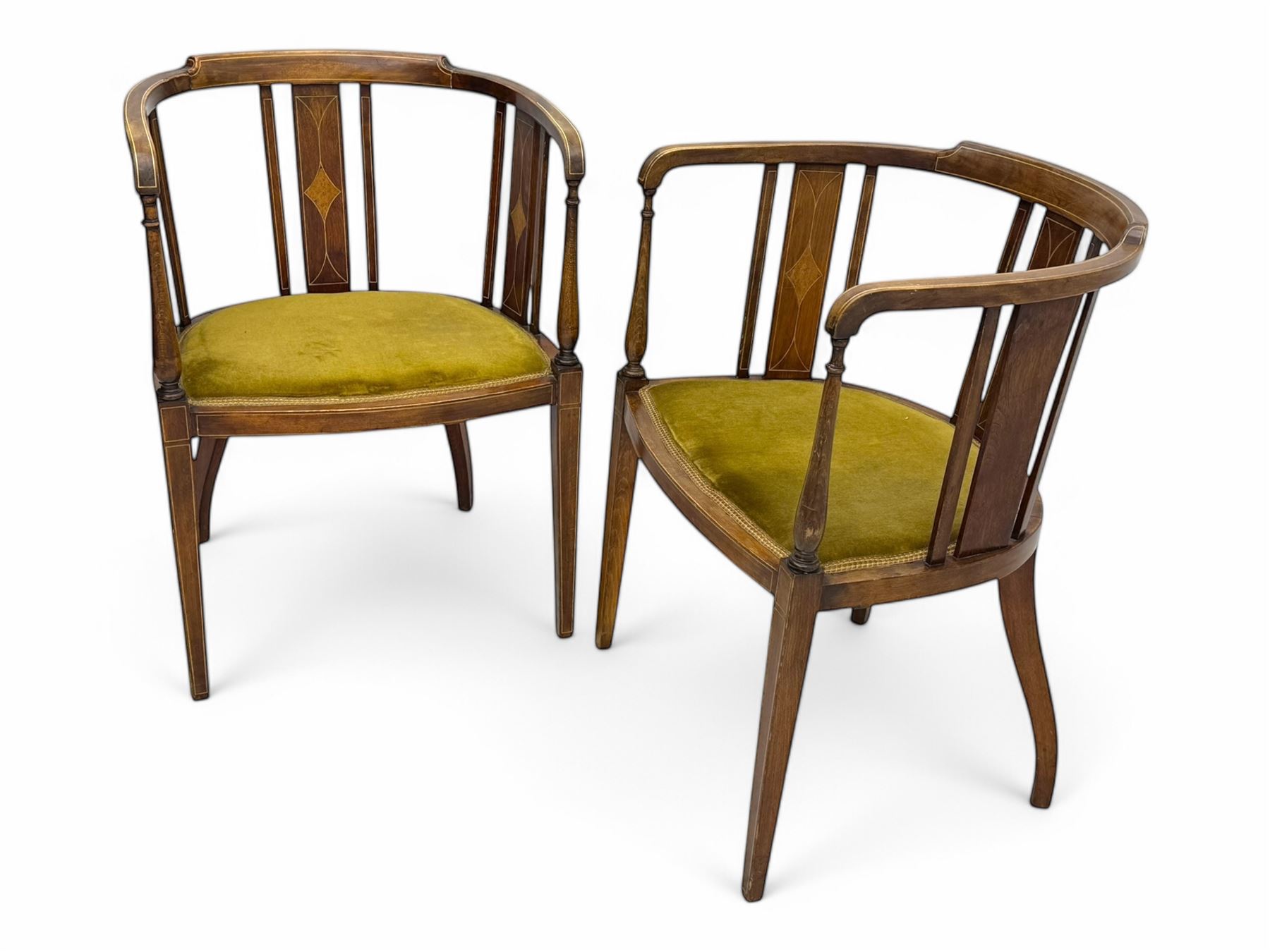 Pair of early 20th century Edwardian inlaid mahogany elbow chairs, shaped top rails with central diamond motif and line inlays, flanked by turned uprights, green velvet seats, on square tapered legs