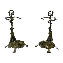 Pair of cast brass hallway umbrella or stick stands, in the form of a tree decorated with trailing flowering foliage branches, the stem with hunting horn over leaning shotgun, shaped naturalist tray base with hunting hound and out splayed foliate cast feet 