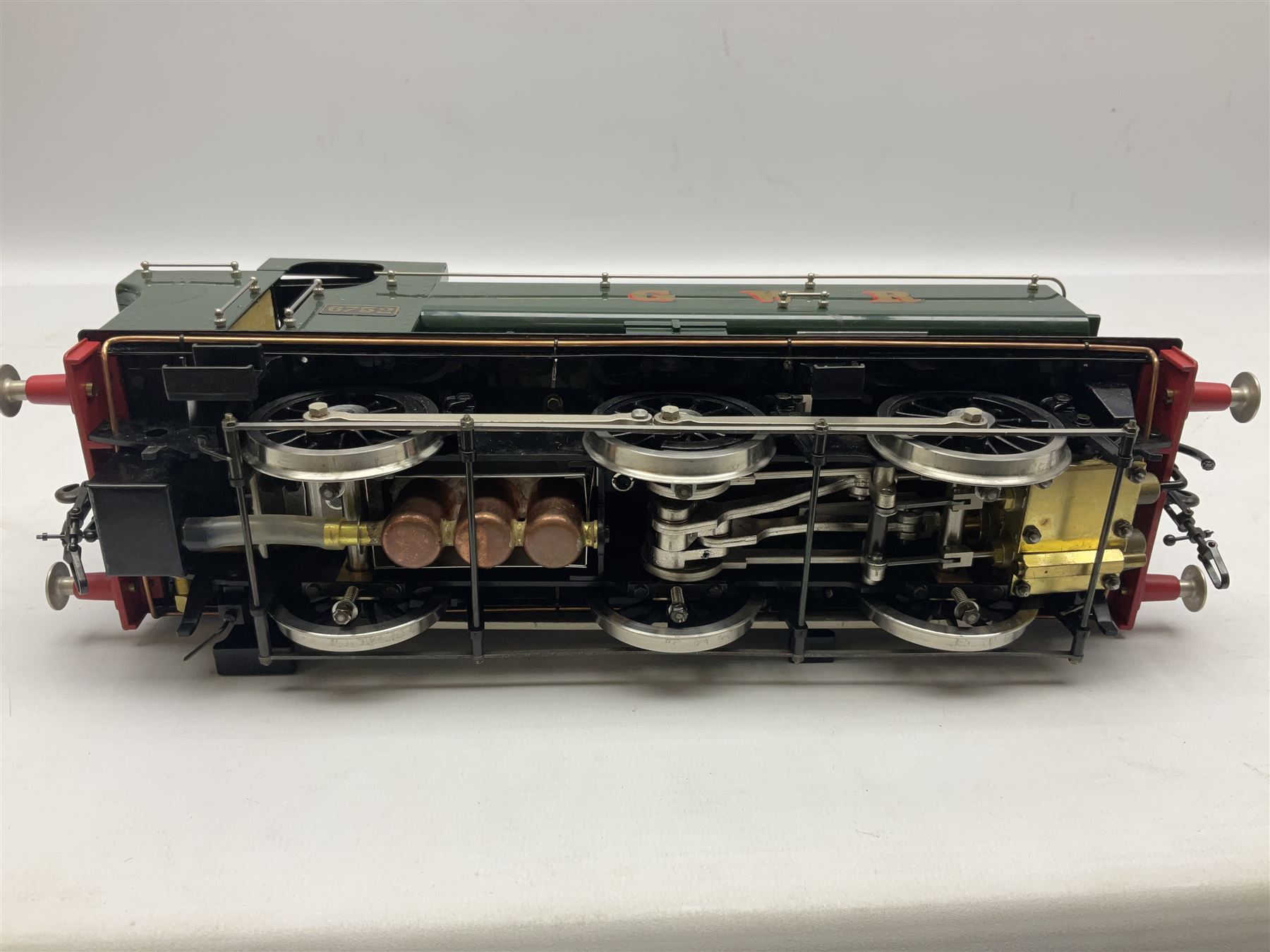 Gauge 1 - Aster 0-6-0 Great Western Railway Pannier tank locomotive No.6752; spirit fired and live steam powered with fitted steam pressure gauge, water sight glass and other usual fittings; finished in Great Western Railway green livery with GWR initials to the pannier tanks, fitted steps, handrails, checker plate, lamp irons, buffers and vacuum hoses; L31cm W8.5cm