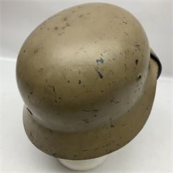 WWII German Luftwaffe M40 steel helmet, sand coloured finish with single decal and leather liner; side apron stamped S.E.64, back apron with indistinct number and top stamped N1