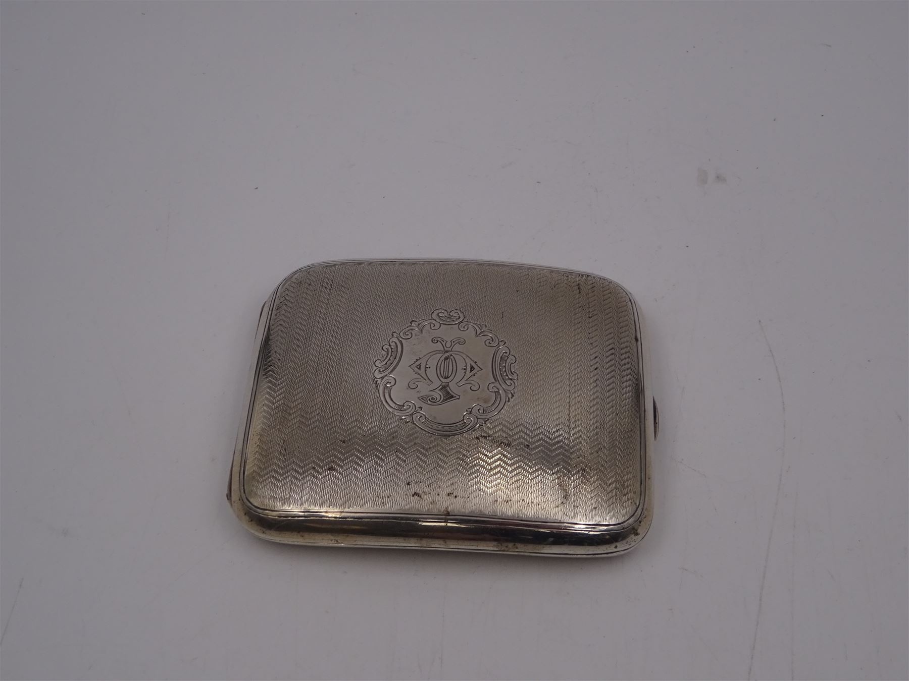 Edwardian silver cigarette case, of rectangular form with engine turned decoration throughout and engraved cartouche to front cover, hallmarked Colen Hewer Cheshire, Chester 1906, H8.6cm