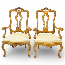 Pair of Italian carved walnut open armchairs, upholstered seats