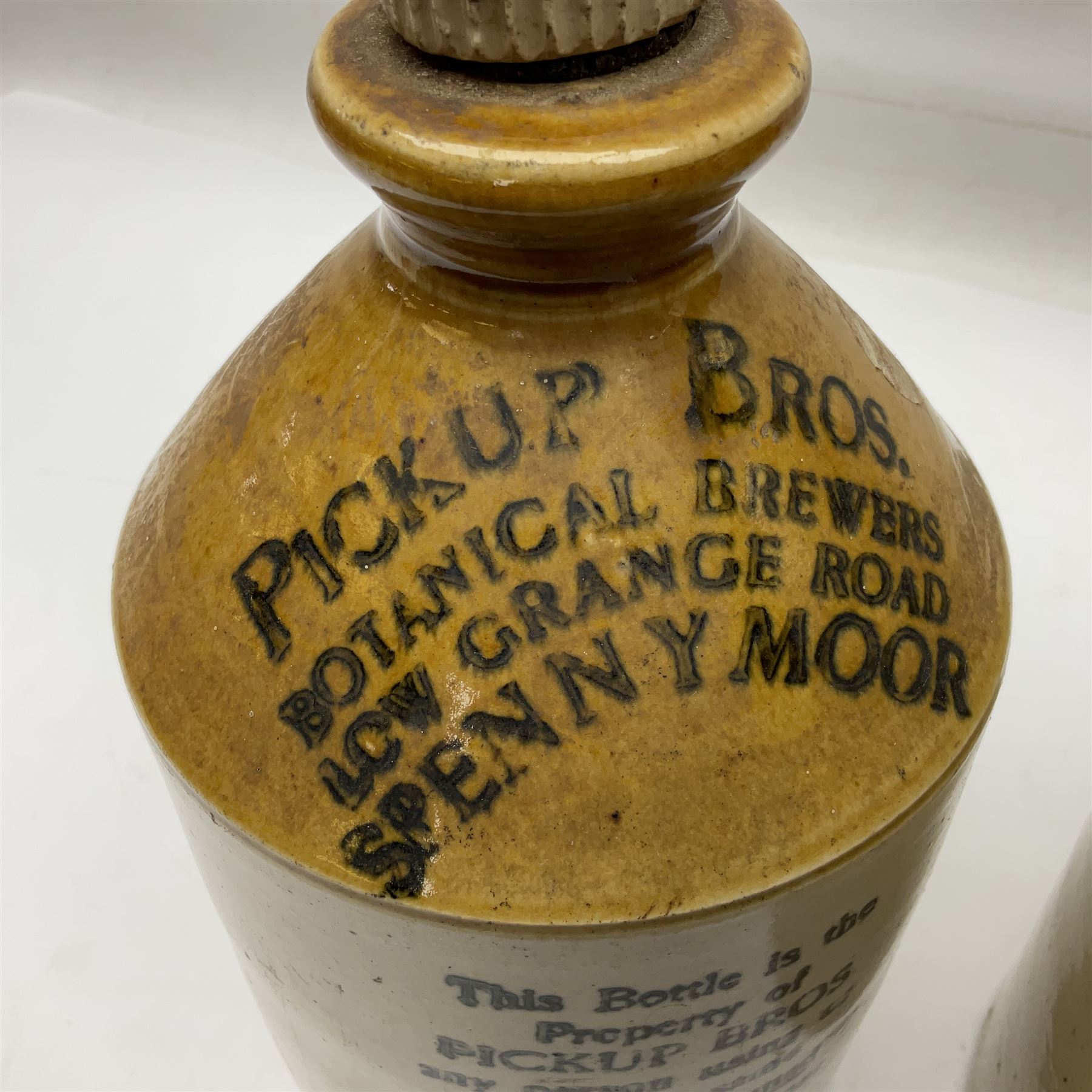 Early 20th century stoneware advertising flagon, marked to front 'Pickup Bros Botanical Brewers', together with a larger stoneware flagon
