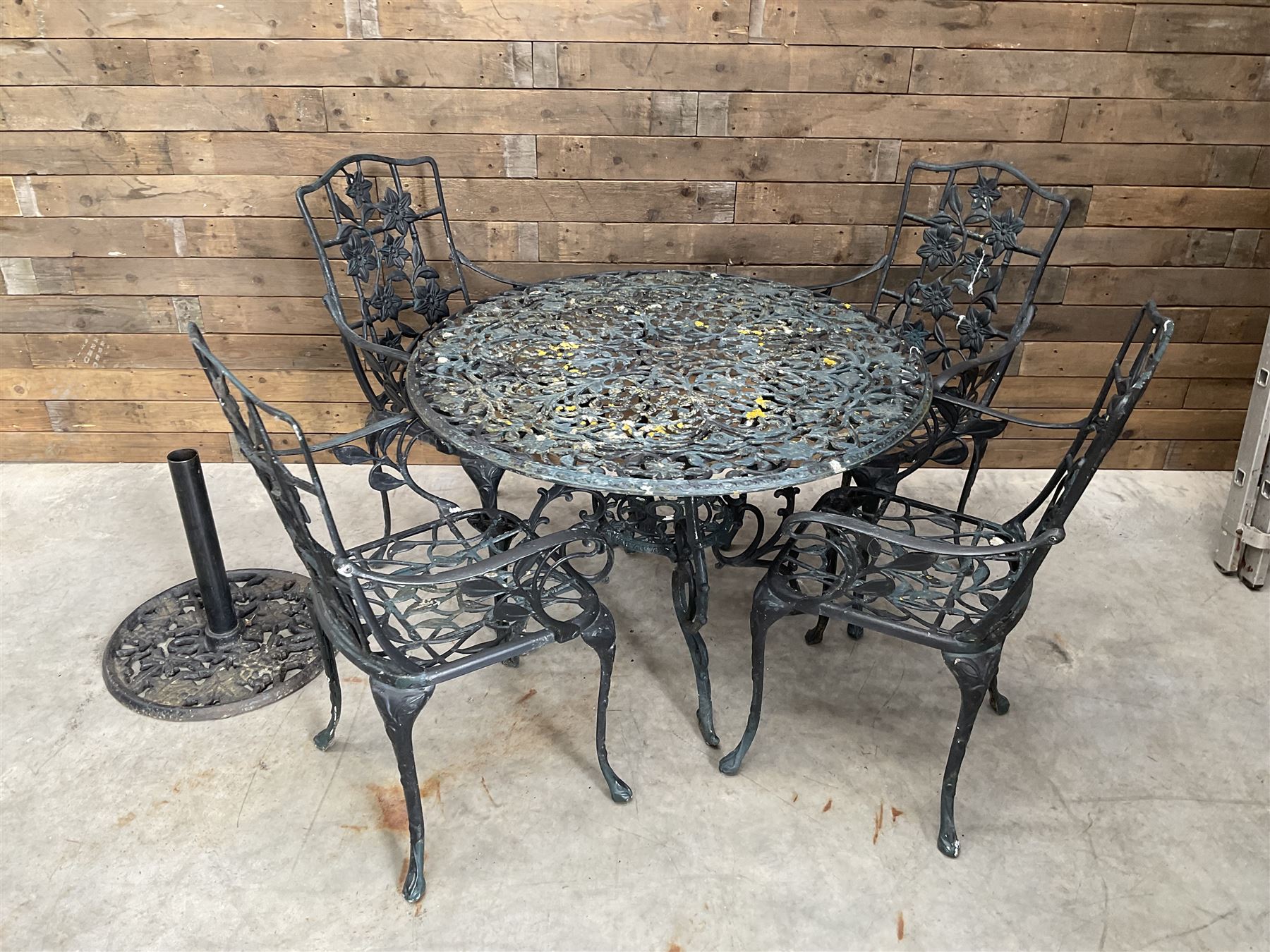 Victorian design painted aluminium circular garden table and four chairs, with parasol base