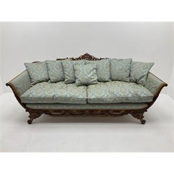 Early 20th century French style beech framed three seat settee, scrolled acanthus leaf and flower head carved cresting rail, the shaped frame carved throughout with a ribbon twist, frieze carved with flower head above garlands, out splayed scrolled feet, upholstered in blue Damask fabric with matching scatter cushions