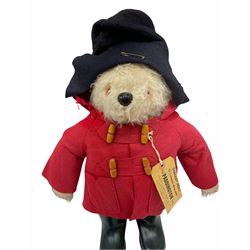 Gabrielle Designs Paddington Bear in a red felt jacket and black felt hat, c1972. Dunlop bottle green wellingtons and Darkest Peru label. H54cm