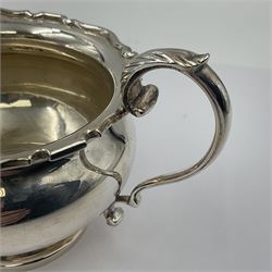 1920s five-piece silver tea service, comprising teapot, coffee pot, hot water pot, twin handled open sucrier and milk jug, each of squat circular form with shaped rim, the teapot, coffee pot and hot water pot each with ebonised handle and finial, the sucrier and milk jug with acanthus capped scroll handles, all upon circular foot, hallmarked R F Mosley & Co, Sheffield 1926 & 1927, tallest H24cm