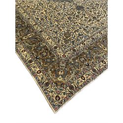 Persian Meshed carpet, ivory ground and decorated with intricate floral design with trailing scrolled branch, the central medallion decorated with stylised plant motifs, seven band border, the main band decorated with scrolls and flower head motifs