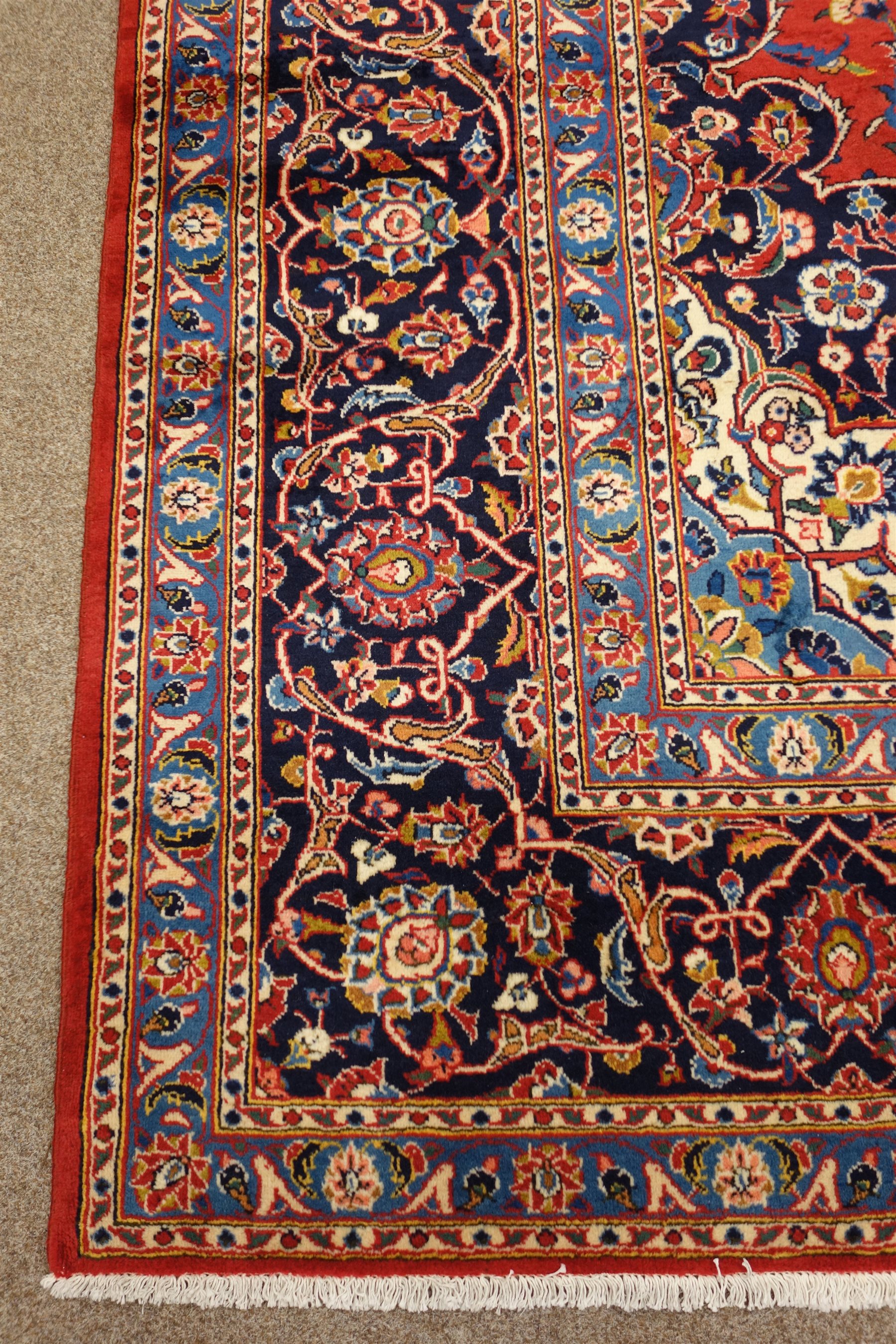 Kashan signed red ground rug, central medallion, repeating border