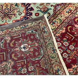North West Persian Tabriz carpet, pastel green ground field with shaped pole medallion, surrounded by interlacing branch and stylised flower head motifs, red ground border decorated with plant motifs